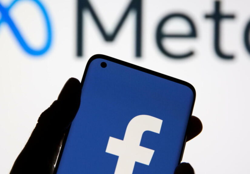 A smartphone with Facebook's logo is seen in front of displayed Facebook's new rebrand logo Meta in this illustration